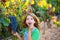 Farmer kid girl in vineyard eating grape in mediterranean autumn