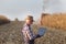 Farmer with laptop at corn harvest