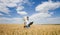 Farmer with laptop and wheat bunch