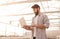 Farmer with laptop working in hydroponic glasshouse