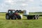 Farmer load hay bales to trailer