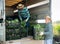 Farmer loading boxes with bok choy into truck