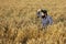 Farmer looking at the distance while adjusting his hat.