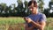 Farmer man talking on mobile phone at field of organic eco farm