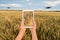 A farmer manages drones with a tablet