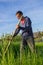 Farmer mowing grass