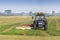 Farmer mowing the grass using a tractor with a mower