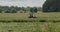 Farmer mows grass, agricultural machinery