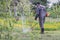 Farmer mows grass in the spring garden. The concept of care for a personal plot