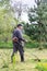 Farmer mows grass in the spring garden. The concept of care for a personal plot