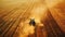 a farmer navigates his tractor across a vast field, operating a large harvesting machine to gather crops under the