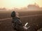 Farmer navigating drone above farmland