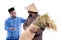 Farmer and partner discussion while holding a bag of rice grain