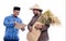 Farmer and partner discussion while holding a bag of rice grain