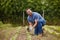 Farmer planting plants or vegetable crops on an organic and sustainable farm and is happy for his seedlings. Excited