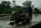 A farmer plowing the rice field using a tractor