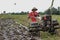 The farmer plows the fields using a tractor