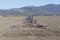 A farmer plows her field