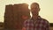 Farmer posing hay bales in sunlight portrait. Focused agronomist inspecting