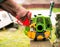 Farmer prepares grass mower for work