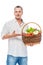 Farmer presents organic vegetables in a basket on a white