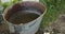 Farmer puts a watering can with milk in the cold water