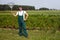 Farmer with rake in raspberry field