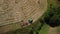 A farmer rakes hay with the help of a tractor hay tiller