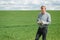 Farmer in red checked shirt using tablet on wheat field. Applying modern technology and applications in agriculture. Concept of