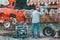 The farmer repairs the harrows if they are damaged by hitting stones. A master welder welds metal parts of agricultural equipment