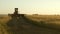 Farmer rides an old combine to work. Combine harvester goes on the way to harvest wheat. old tract. Wheat field