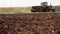 Farmer Rides On Tractor Across the Field