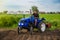 Farmer rides a tractor across the field. Milling soil. Work in the field and preparation of the land for planting of seedlings