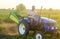 The farmer rides a tractor. Work on small farms. Support and subsidies. Farming and farmland. Campaign harvesting potatoes