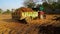 Farmer riding the tractor for unloading the trolley full of fertilizer outdoor in the field located in rural India