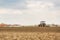 Farmer seeding, sowing crops at field.