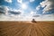 Farmer seeding, sowing crops at field.