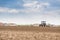 Farmer seeding, sowing crops at field. Sowing is the process of planting seeds in the ground as part of the early spring time agri