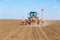 Farmer seeding soybeans with pneumatic seeder.