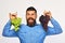 Farmer shows his harvest. Winegrower with cheerful face holds grapes