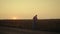 Farmer silhouette check grain quality at sunset country field. Thoughtful man