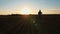 farmer silhouette. Human walking on agricultural field, at sunset. in backlight. farming