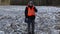 Farmer with smartphone on frozen field in winter