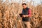 Farmer smiling and enjoying harvesting. young farmer using technology and harvesting corn