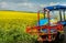 farmer sprayer tractor near oilseed rape fields