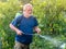 farmer spraying copper fungicide to organic vines