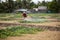 Farmer spraying fertilizer for fruit and vegetables on field