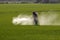 Farmer spraying pesticide in paddy field