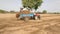 Farmer spreading fertilizer  by tractor in field, May, 10, 2020 - Jodhpur/ India