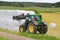 Farmer Stacks up Silage with Front Loader John Deere 6330 Tractor